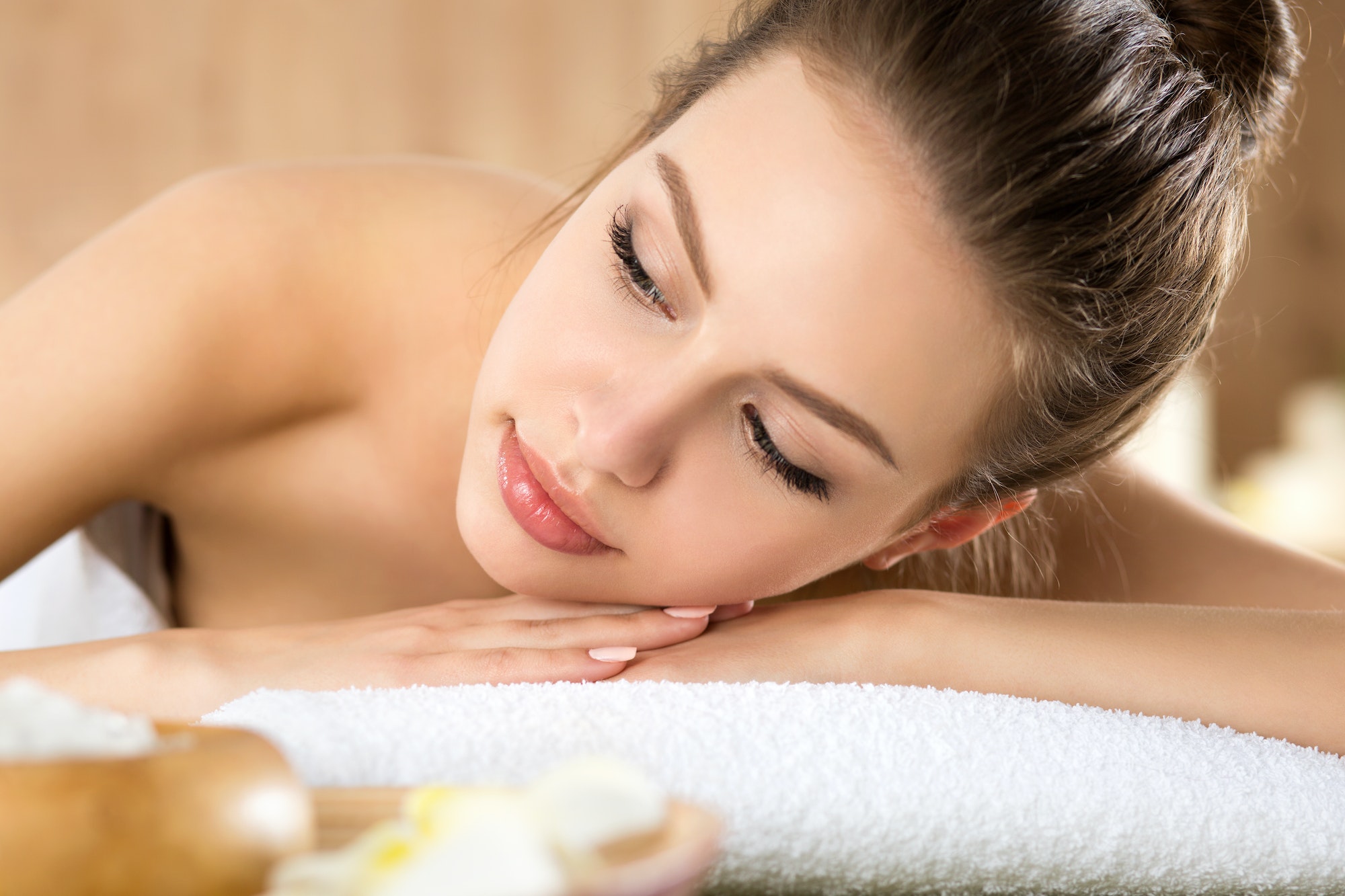 A young woman laying on the spa table.
