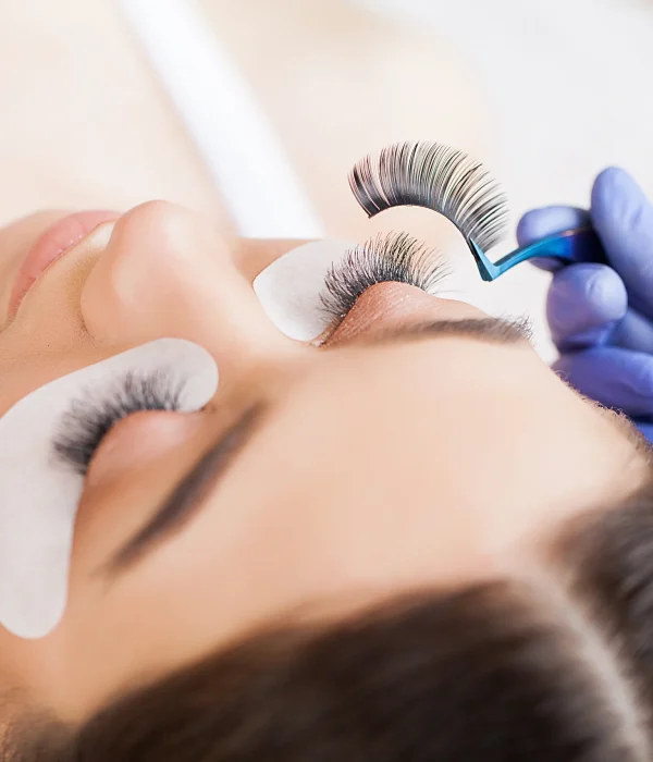 A professional stylist lengthening the clients eye lashes.